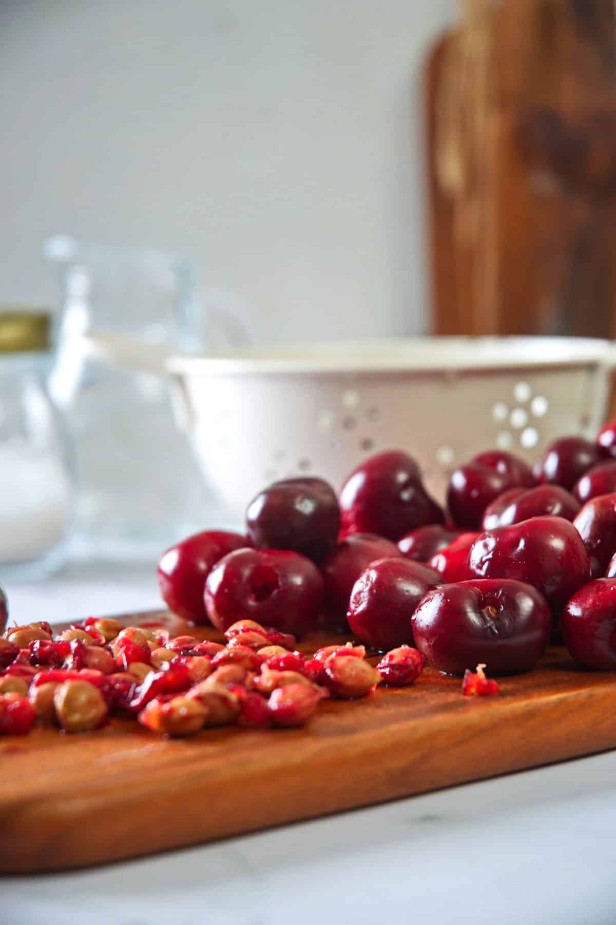 Pitted cherries on wooden board.