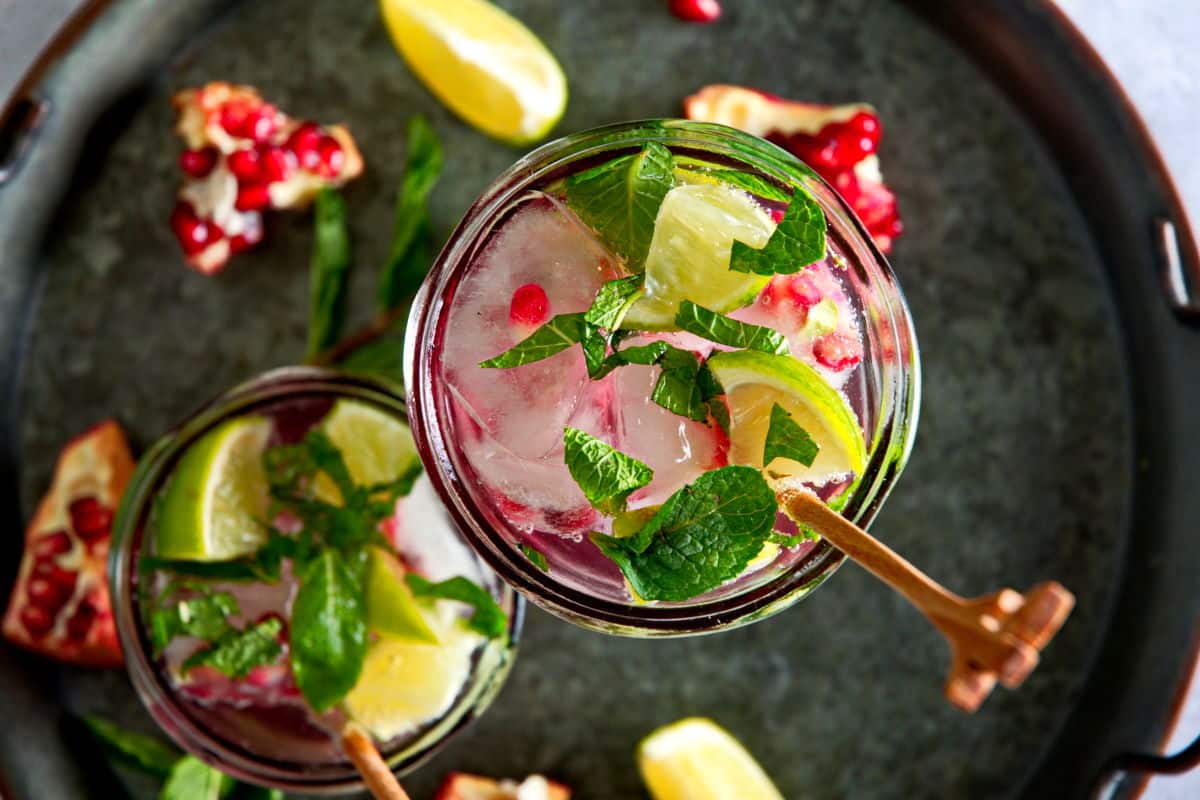 Top view of pomegranate mojito mocktail on tray.