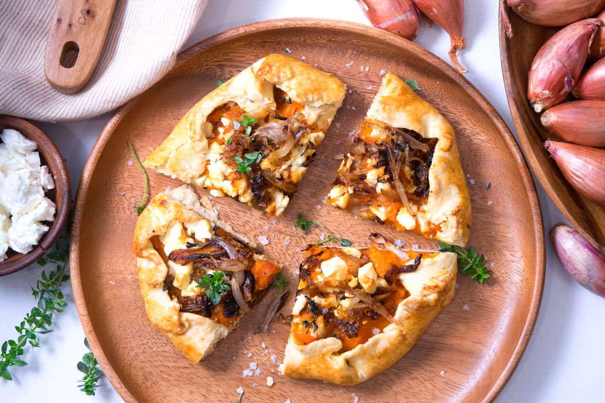 Sliced pumpkin galette on wooden plate.