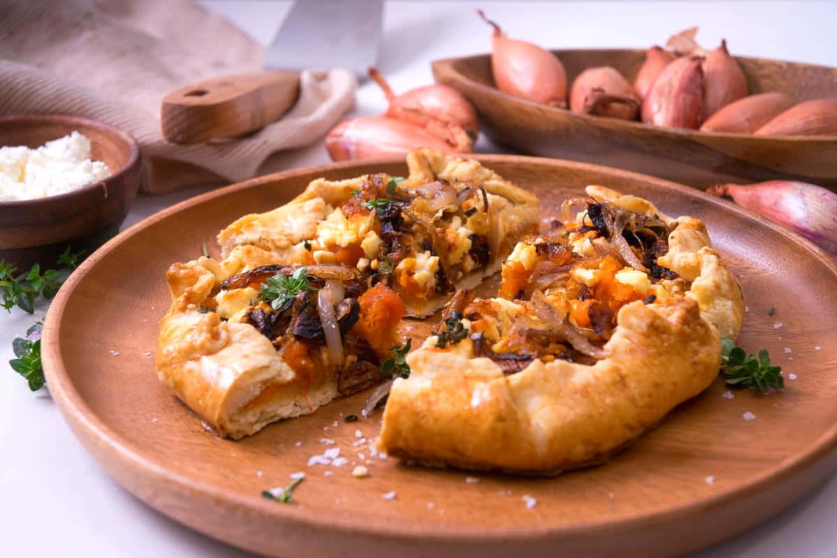 Sliced pumpkin galette on wooden plate.