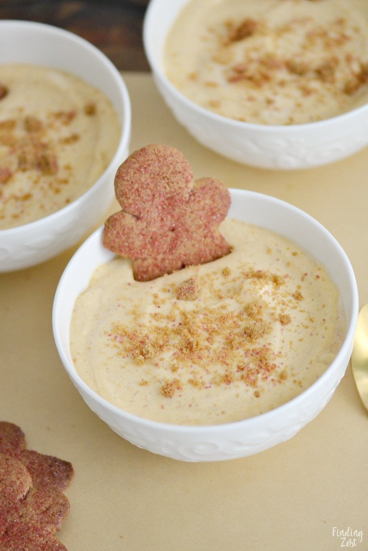 Pumpkin pudding with gingerbread cookies in white bowls.