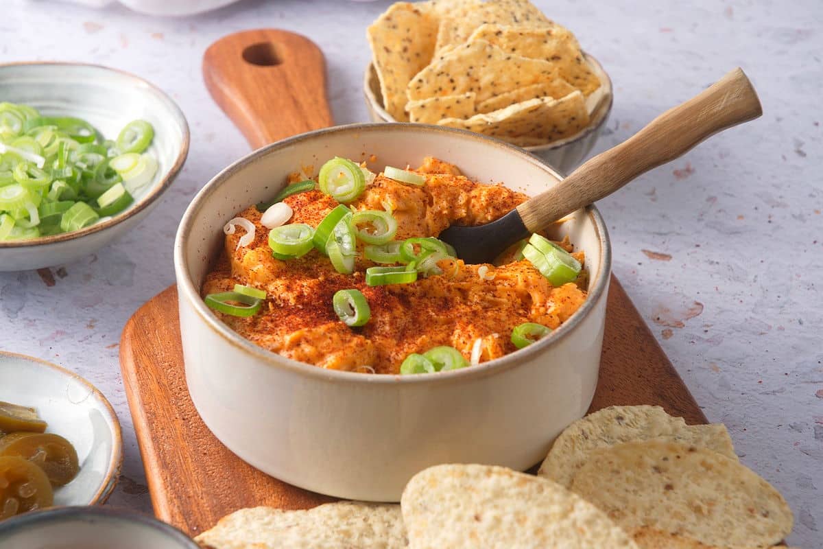 Buffalo chicken dip in dish with small spoon.