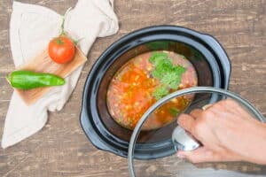 Mexican soup in a slow cooker with a lid.