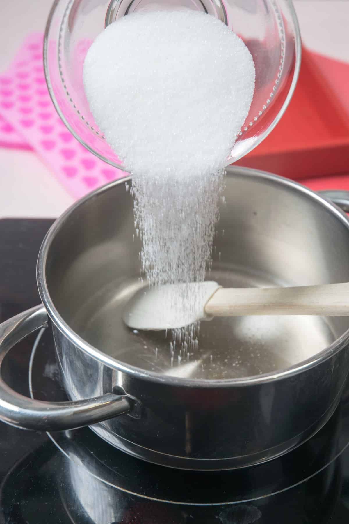 Sugar and syrup in a saucepan with spatula.