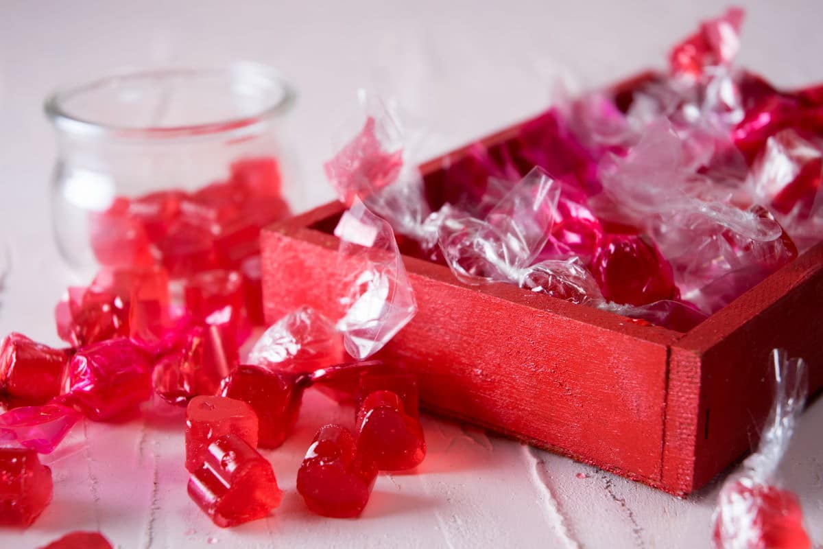 Wrapped strawberry hard candies in a red box.