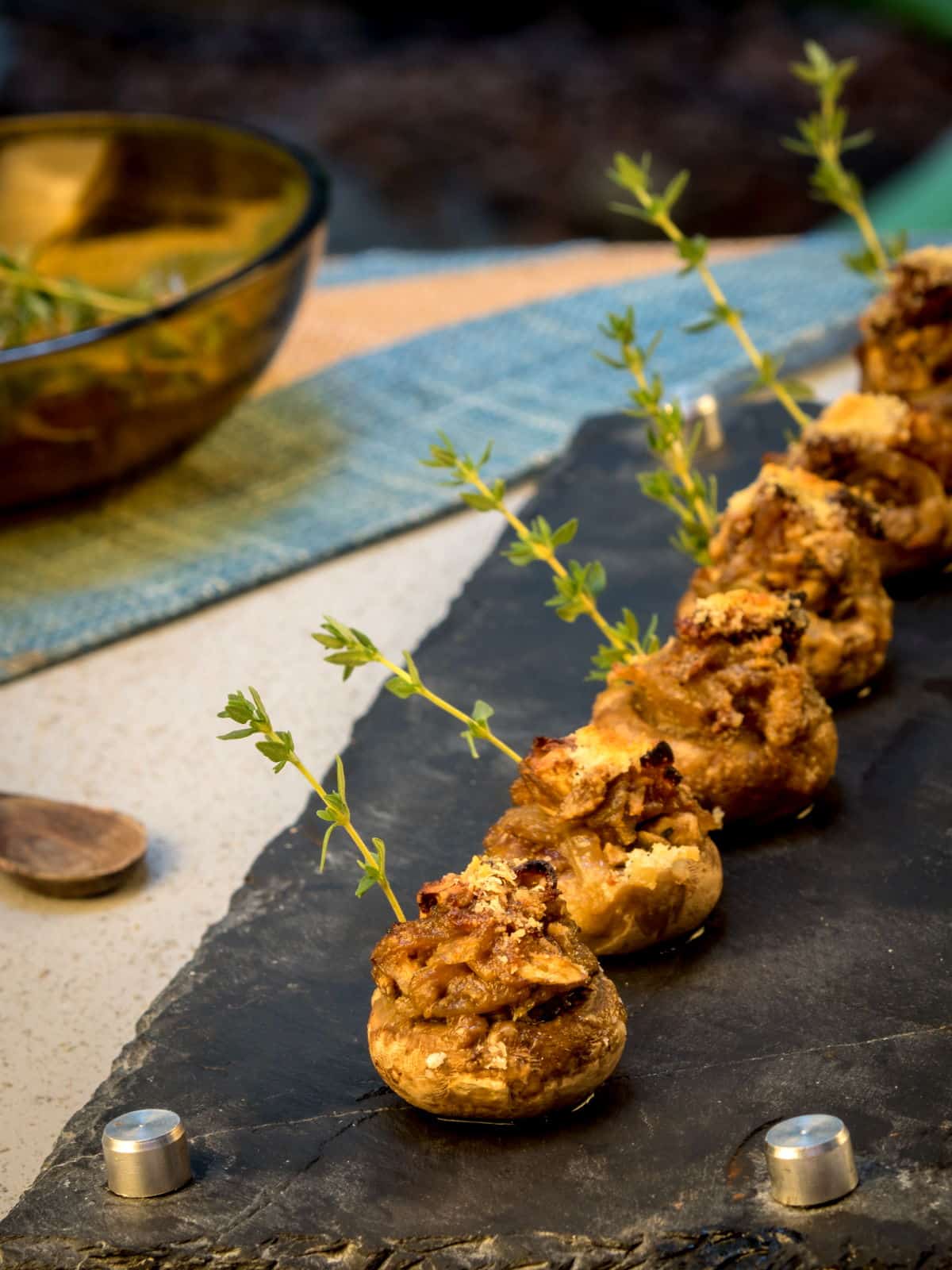 Stuffed button mushrooms lined up beside each other.