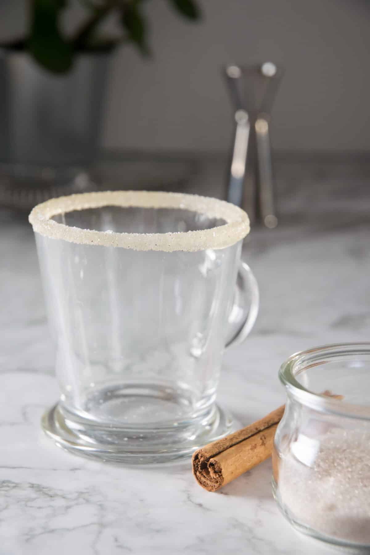 Sugar rim on coffee glass on marble background.