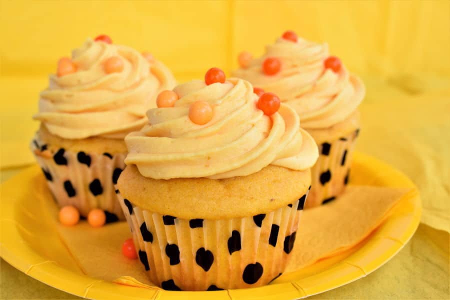 Pumpkin cupcakes with pumpkin buttercream and orange candy balls.