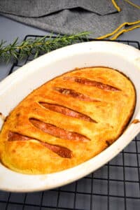 Toad in the hole in a large casserole dish on baking rack.