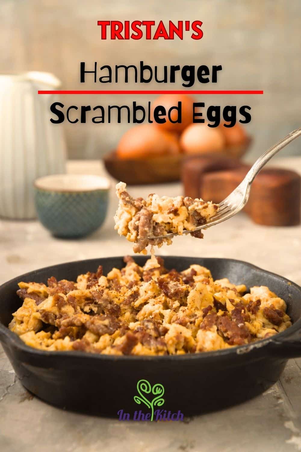 Hamburger scrambled eggs in cast iron pan with fork and text overlay that says 'Tristan's hamburger scrambled eggs'.