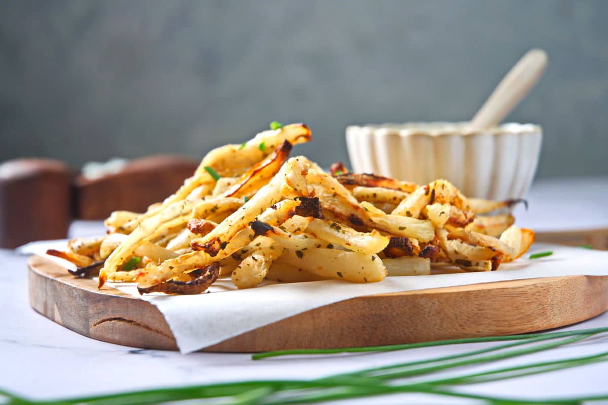 Golden turnips fries on cutting board.