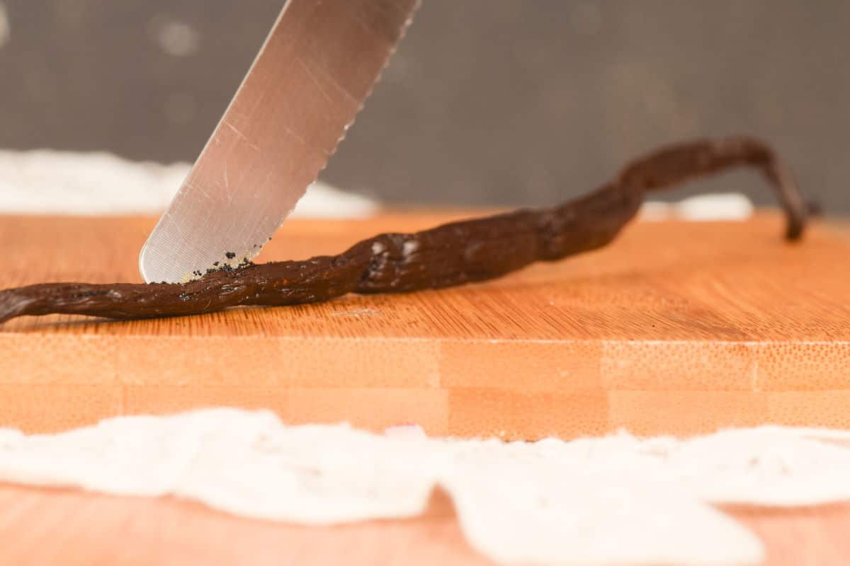 Slicing into a vanilla bean pod.