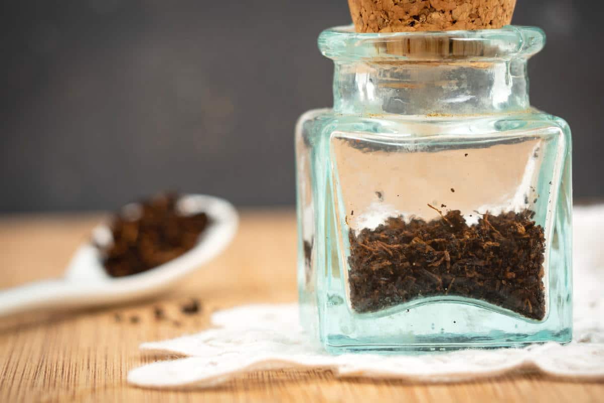 Vanilla powder in a glass jar with cork top.