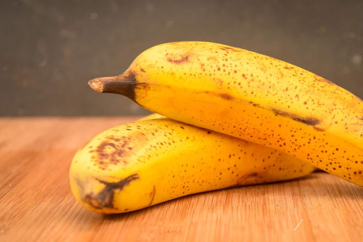 Bananas on a cutting board.
