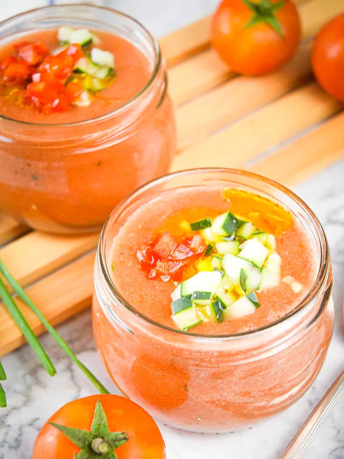 Watermelon tomato gazpacho in small jars.