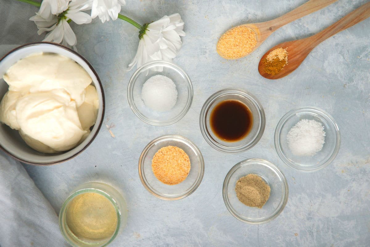 White bbq sauce ingredients prepped on light blue-grey background.