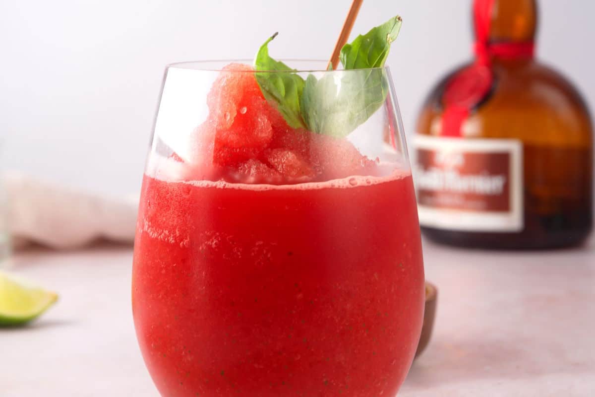 Watermelon basil cocktail with Grand Marnier in the background.