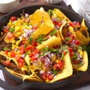 Bison brisket nachos in cast iron pan.
