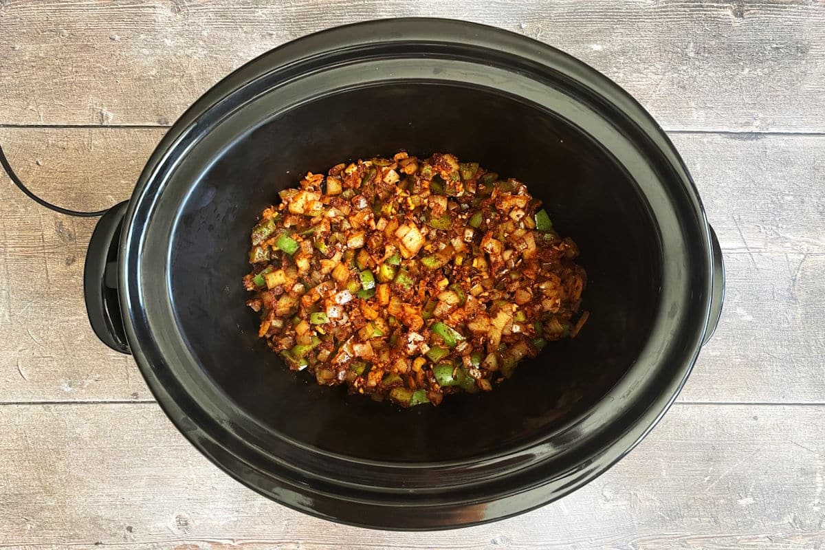 Cooked vegetables and spices in slow cooker.