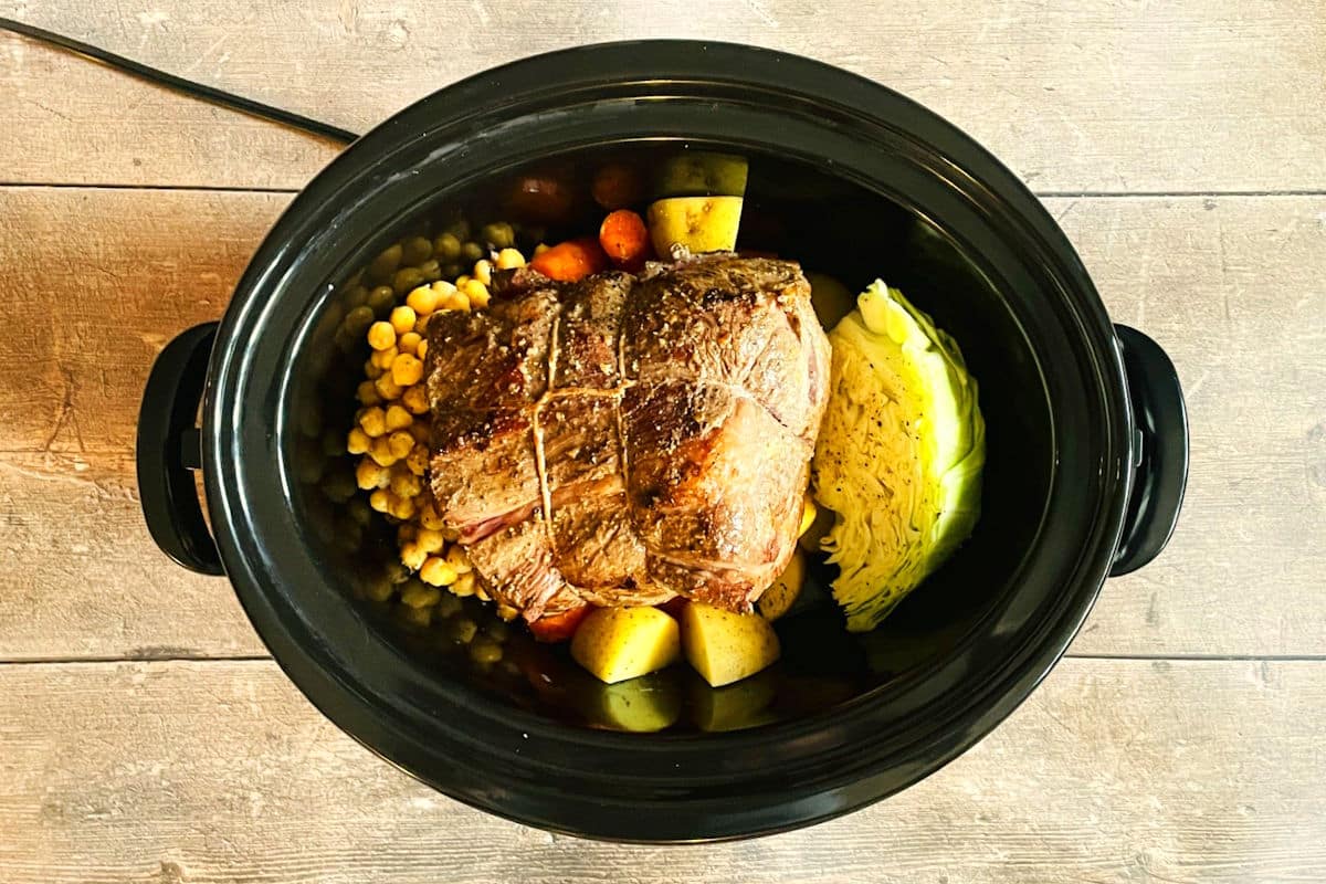 Vegetables and seared bison chuck roast in slow cooker.