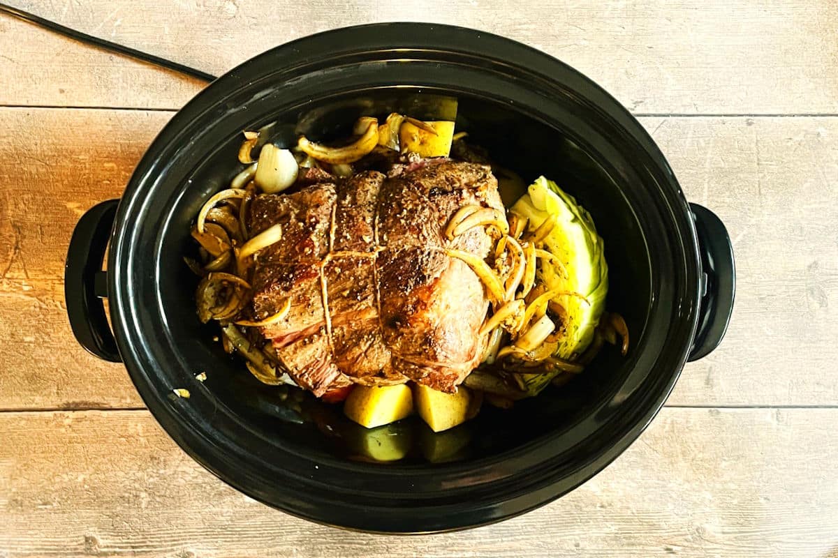 Vegetables, bison roast and onions in slow cooker.