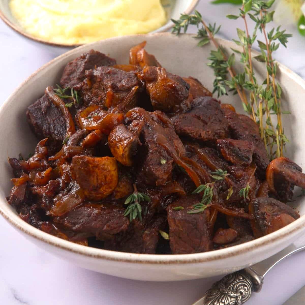 Bison stew in bowl with fresh thyme.