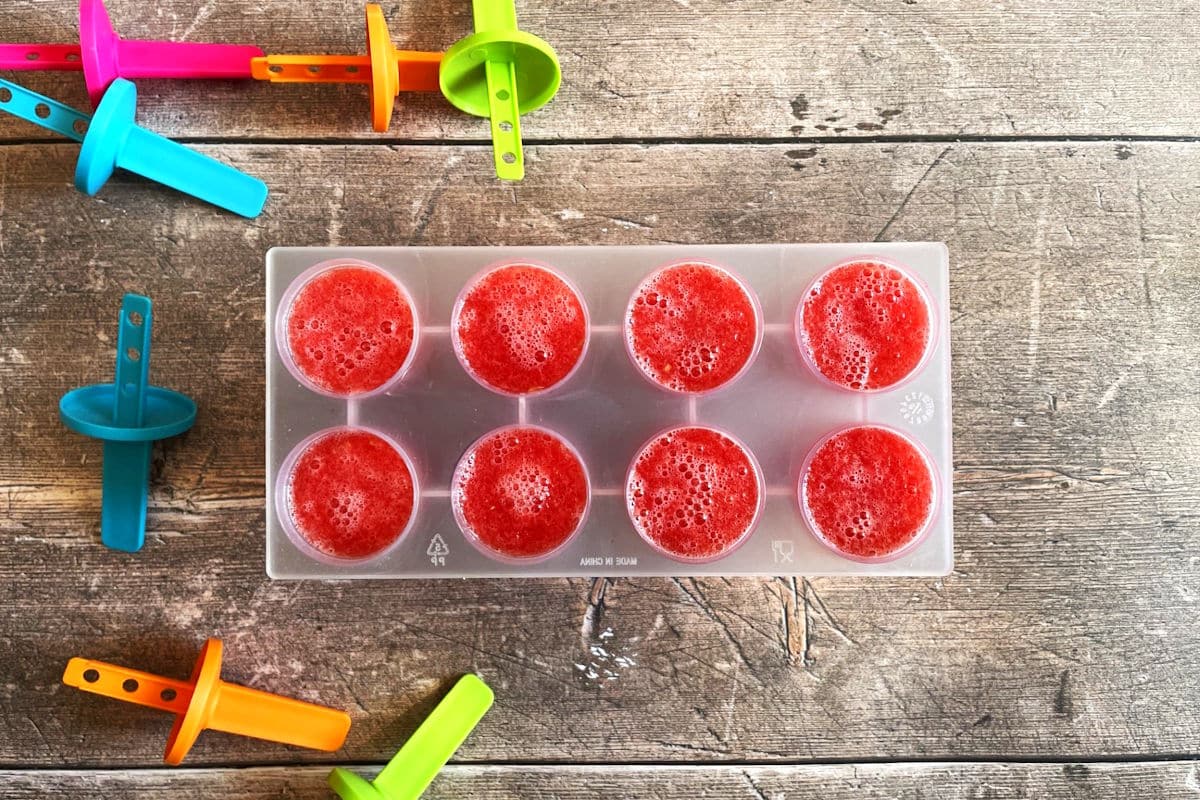 Blended watermelon in popsicle mold.