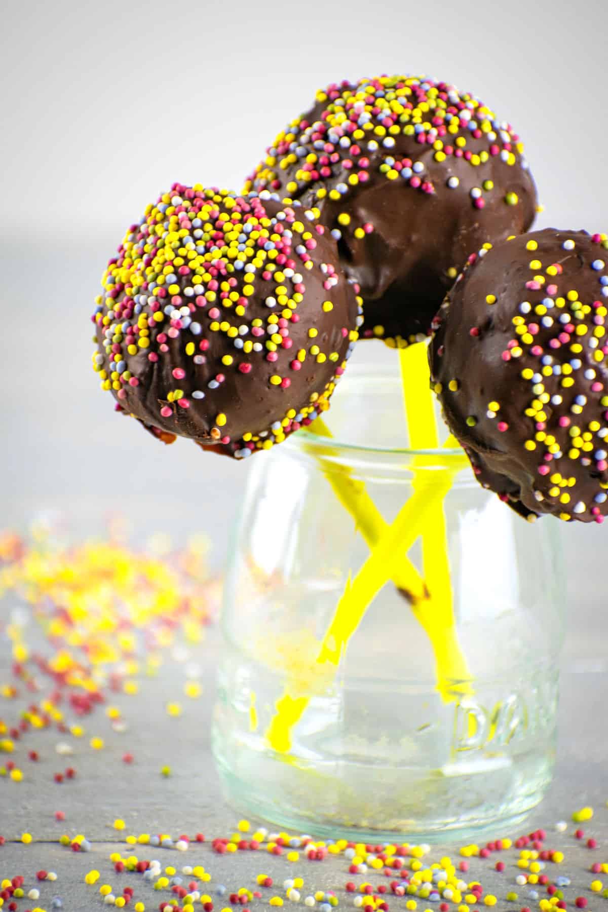 Chocolate covered cake pops made with silicone mold in small jar.