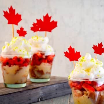 Canada Day mini cakes in cups with maple leaf decorations.