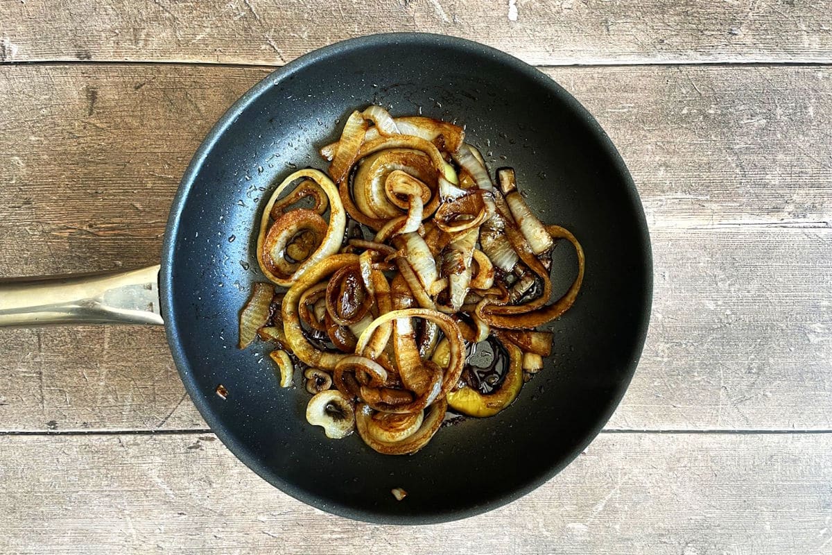 Caramelized onions with balsamic in pan.