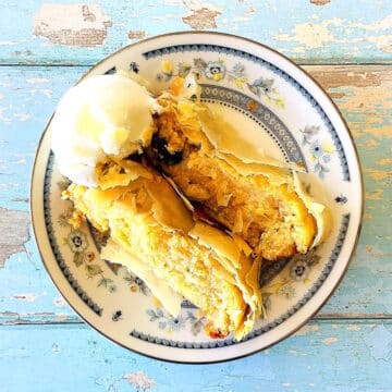 Sliced cheese strudel with a scoop of ice cream.