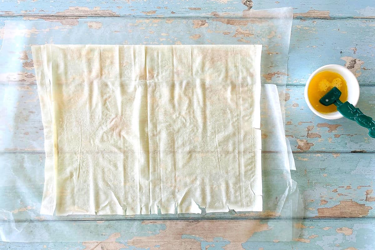 Phyllo pastry sheet with butter on the side.