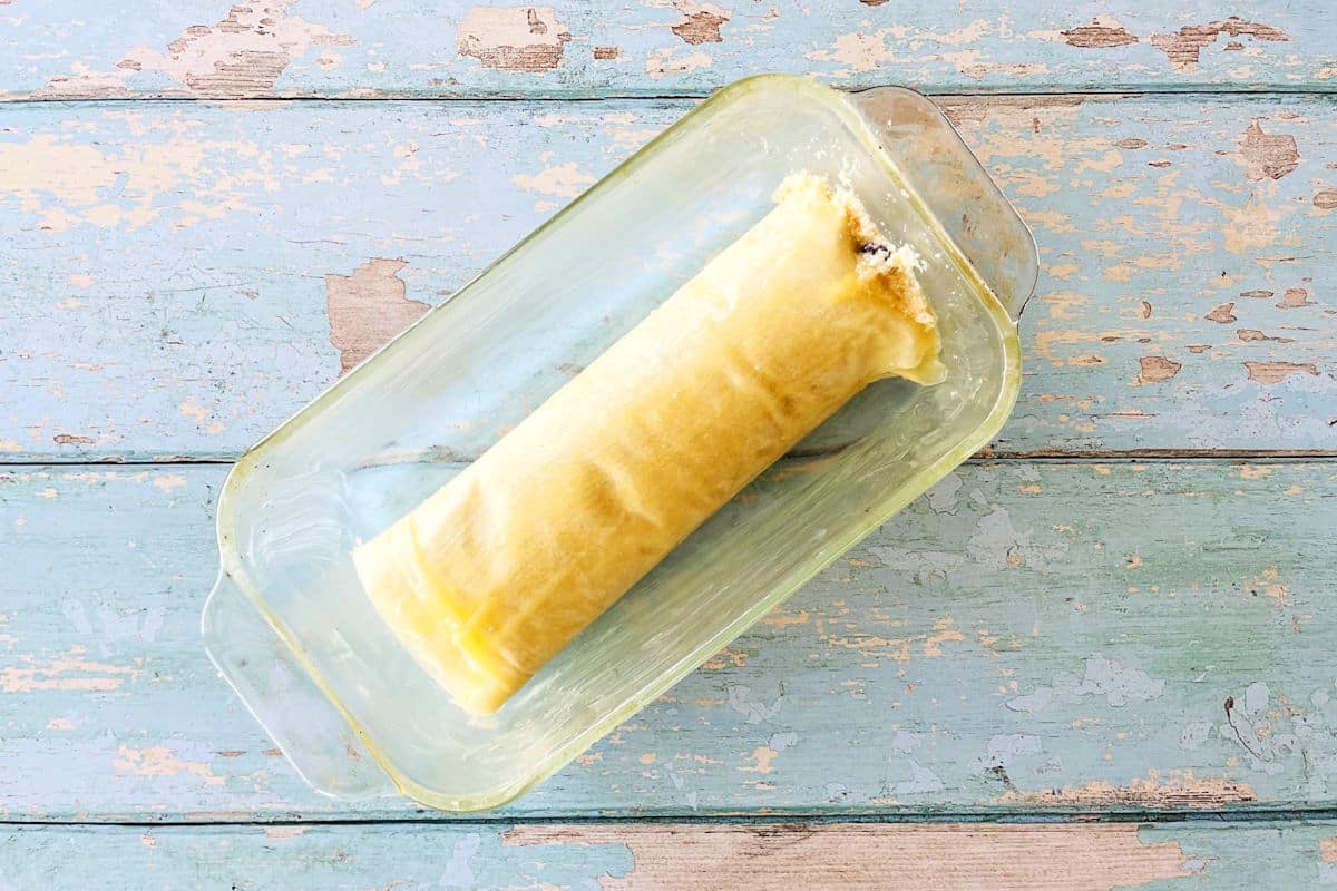 Raw cheese strudel in baking pan.