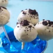Cookies and cream cake pops in a blue mini pail.