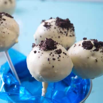 Cookies and cream cake pops in a blue mini pail.