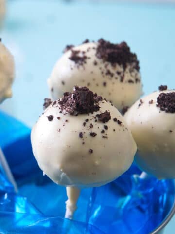 Cookies and cream cake pops in a blue mini pail.