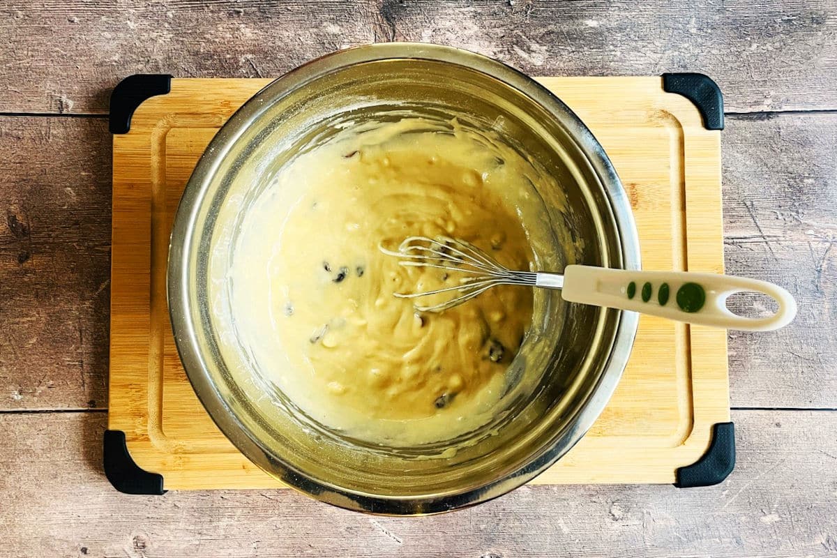 Cranberry white chocolate cake pop batter in bowl with whisk.