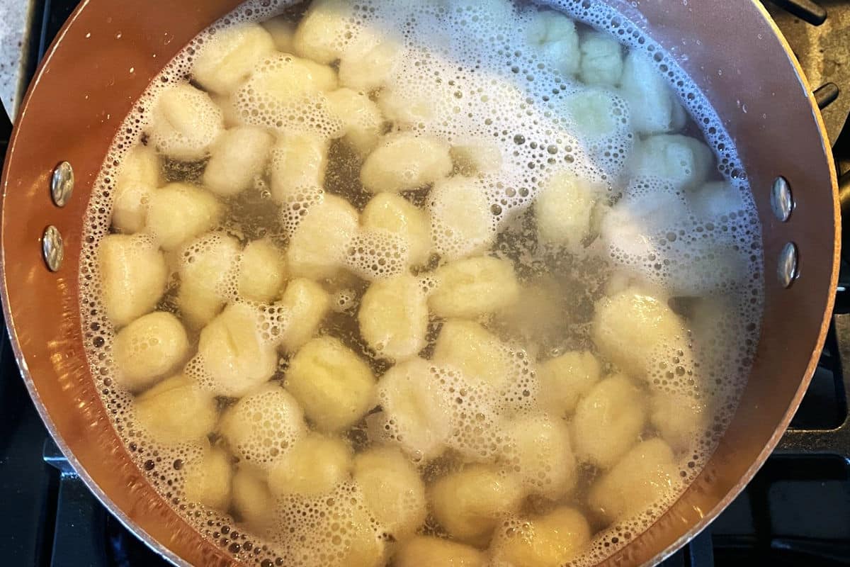Gnocchi in pot of boiling water.