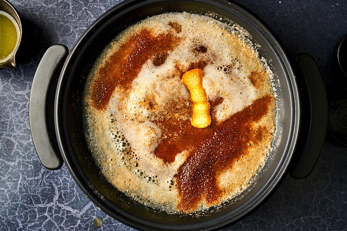 Brown sugar, butter and orange peel in electric skillet.