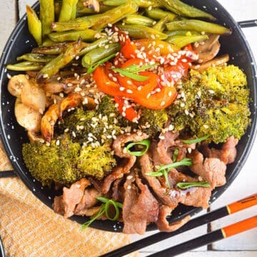 Beef and broccoli in black bowl.