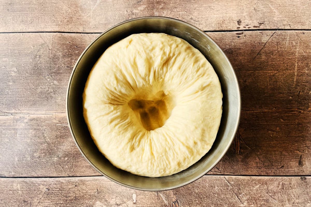 Dough ball punched down in bowl.