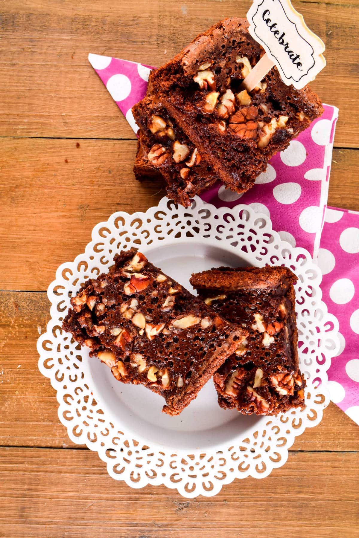 Electric skillet brownies sliced and stacked on white plate.