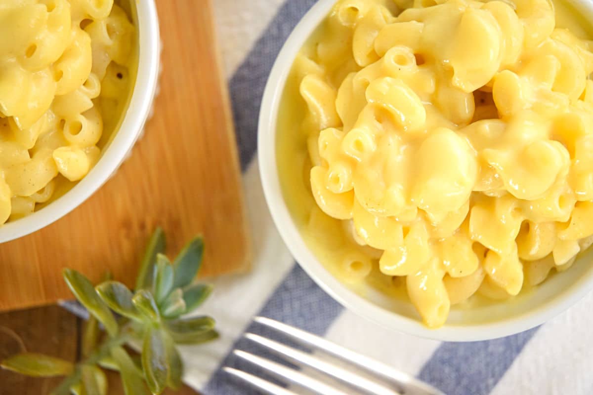 Creamy electric skillet mac and cheese in white dishes.