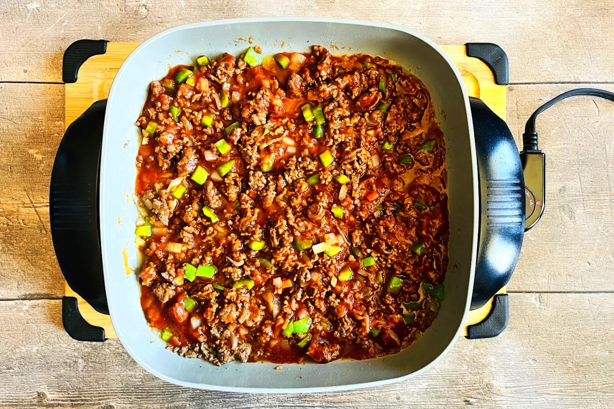 Sloppy Joe mixture cooking in electric skillet.
