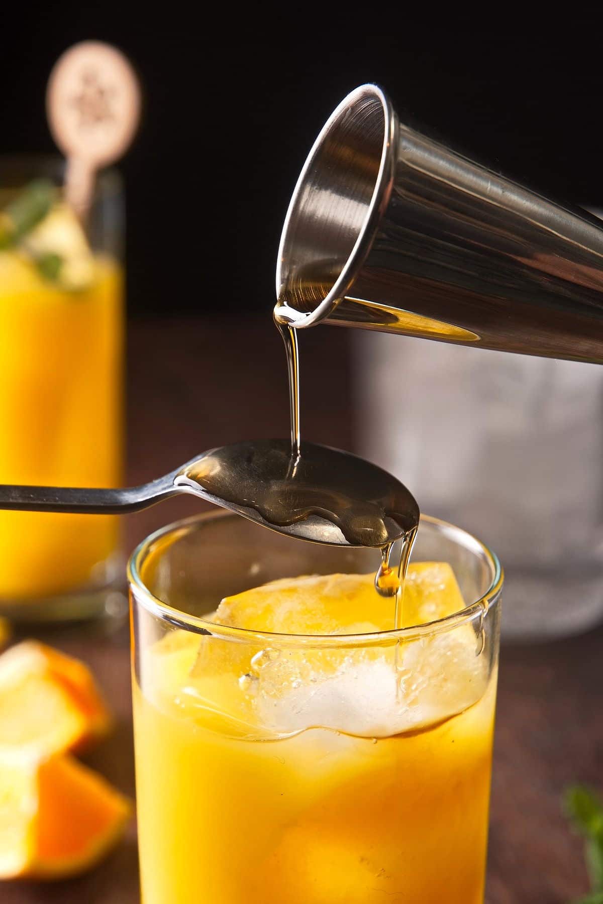 Sherry floating over spoon into fog cutter drink.