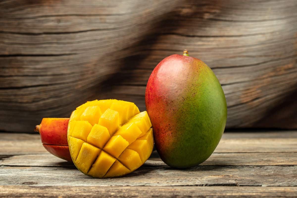 Mango tropical fruit on wooden background.