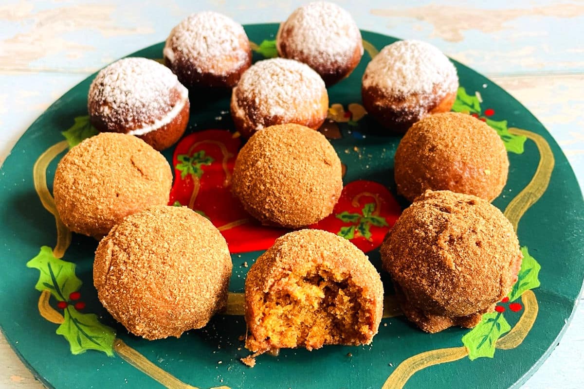 Gingerbread cake balls on festive plate dusted with sugar.