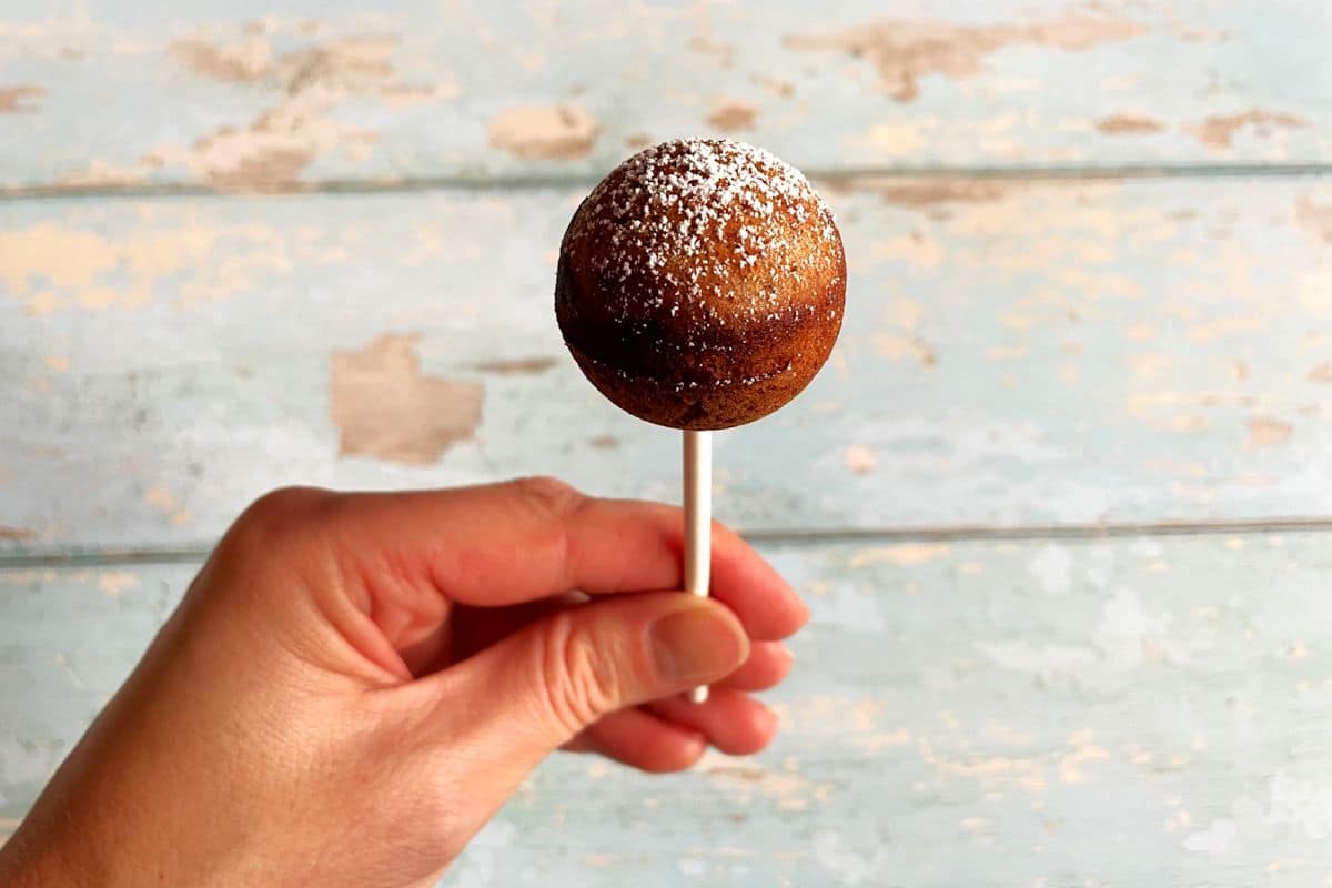 Gingerbread cake pop in hand.