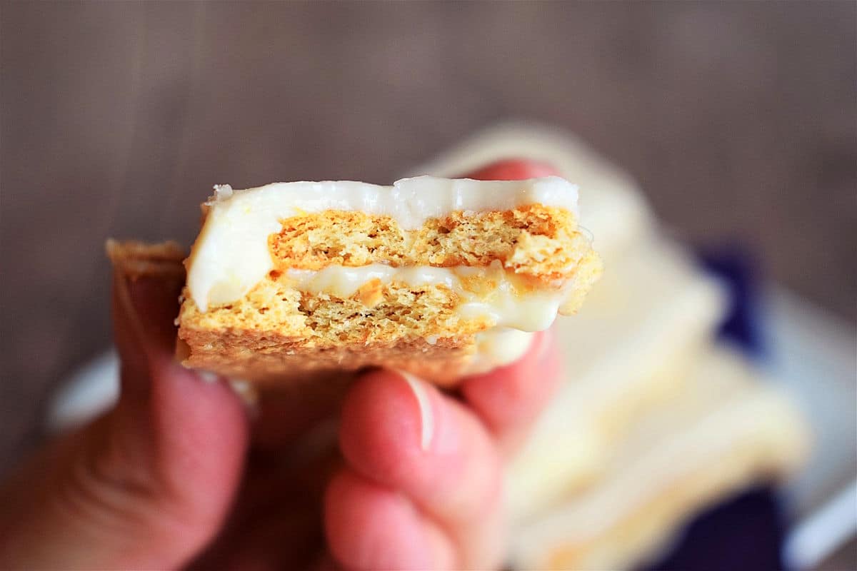 Graham wafer lemon bar bitten into in hand.