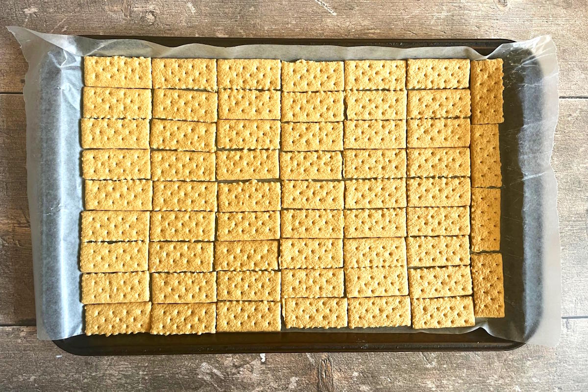 Layer of graham wafers on cookie sheet.